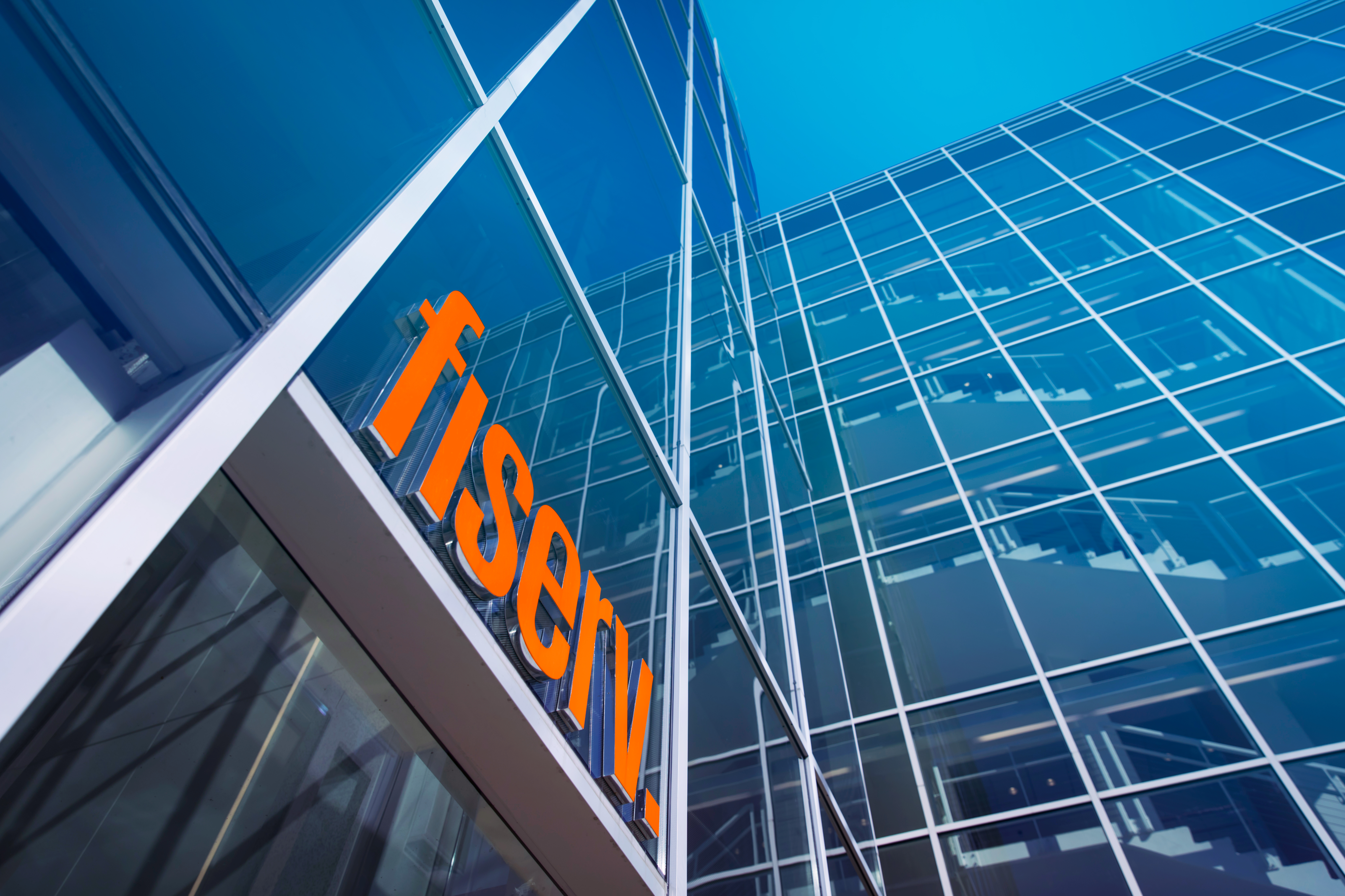 looking up at Fiserv. Company building and blue sky